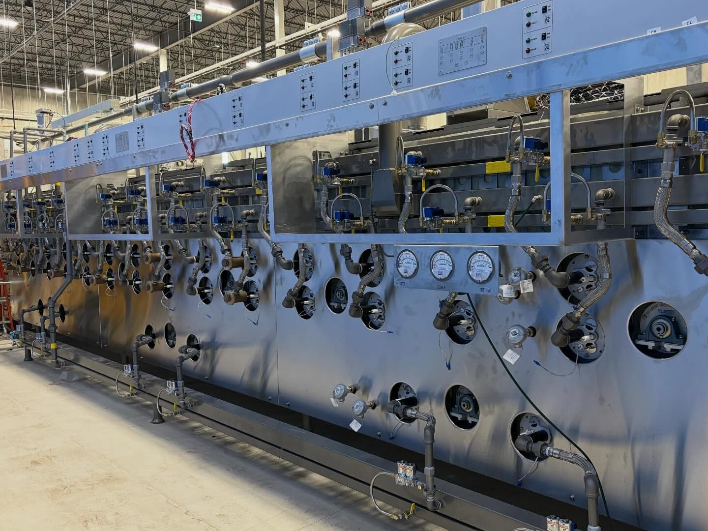 A refrigeration rack with gauges and valves, photographed by Dundas Mechanical (Instagram, March 2026)